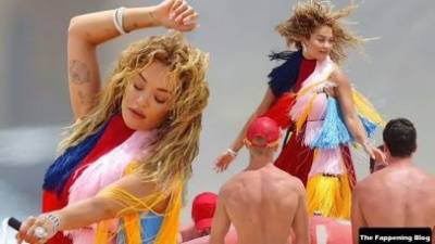 Rita Ora Wears a Bright Dress as She Does a Sexy Shoot at Maroubra Beach on girlsfans.net