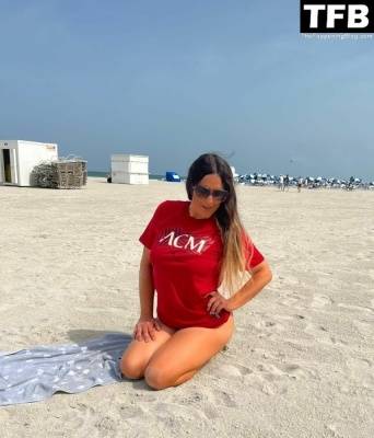 Claudia Romani Supports AC Milan on the Beach in Miami on girlsfans.net